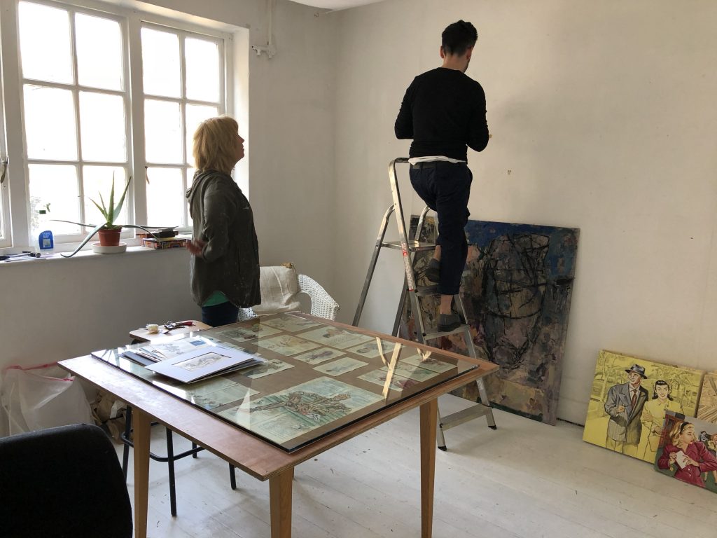 Paolo Fiorentini and Teresa Witz hanging items in preparation for the Apartment #10